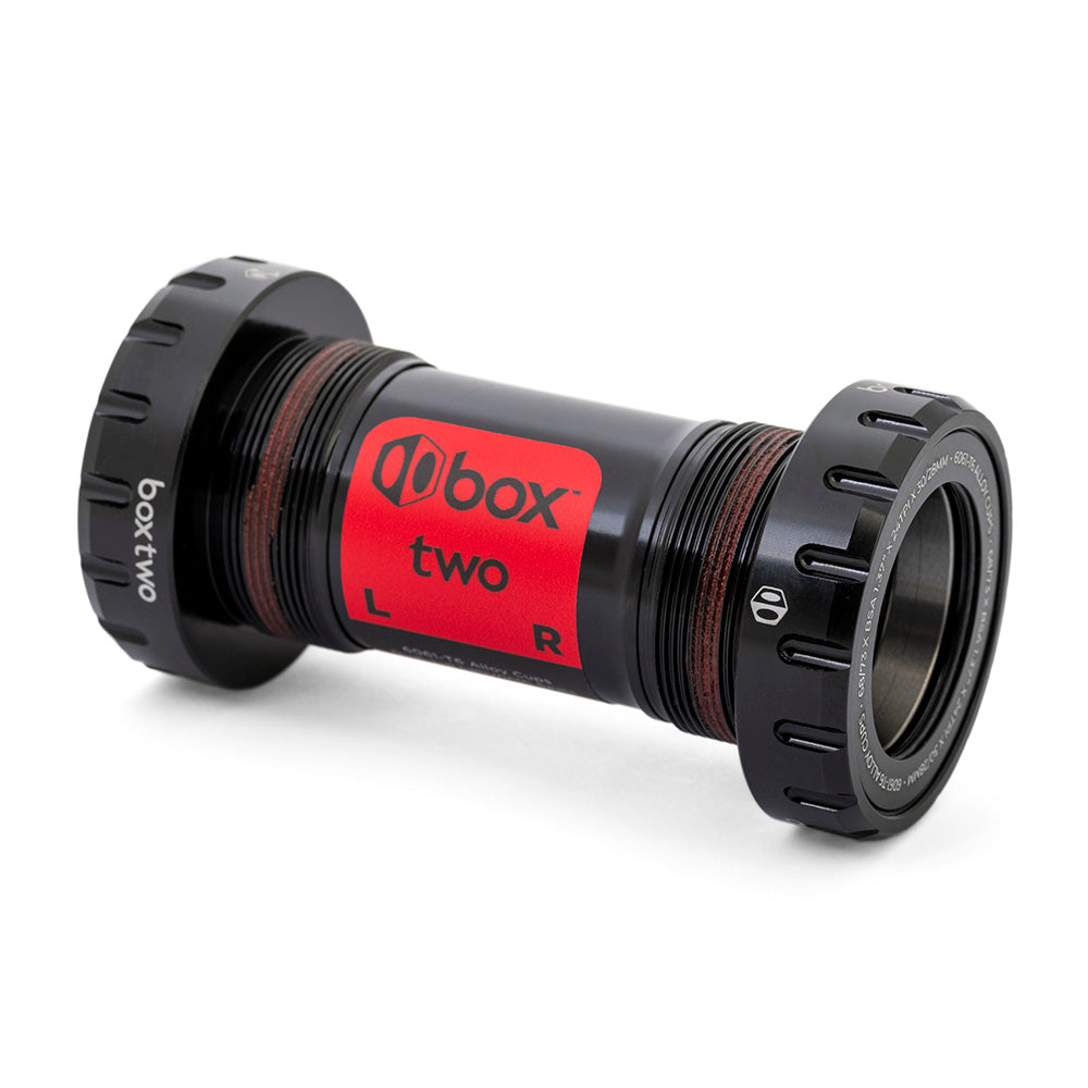 Box Two Oversized 30mm Bottom Bracket SSS Racing: black anodized aluminum body, red label, knurled caps, sealed bearings.