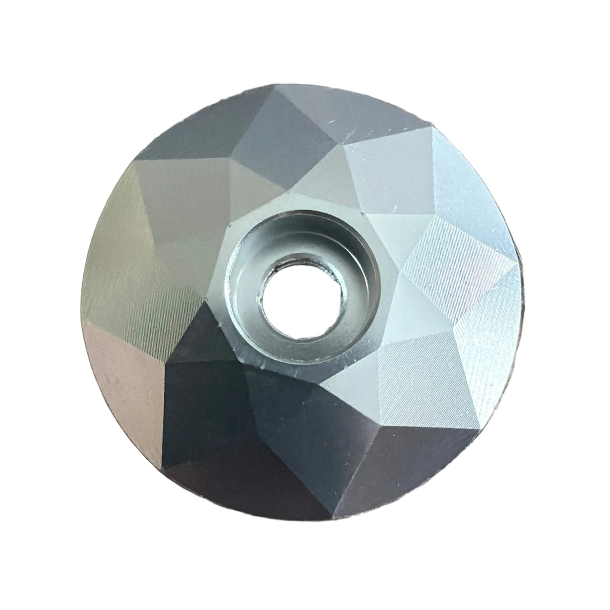 Stem Headset Top Cap with a faceted silver-gray hexagon surface, circular bore, metallic geometric texture and subtle shine.