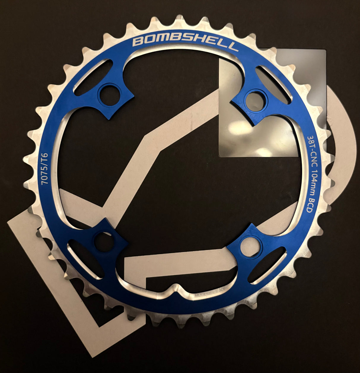 Bombshell Chainring by SSS Racing in blue anodized aluminum with silver CNC teeth, cutouts, 104mm BCD, 7075/T6 lightweight