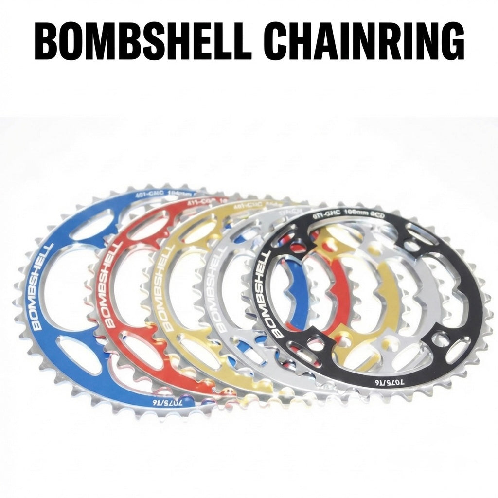 Bombshell Chainring by SSS Racing in assorted anodized aluminum colors (blue, red, gold, silver, black) with sharp teeth.