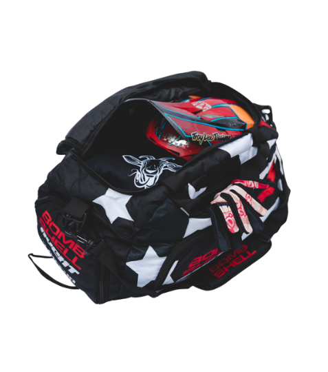 Bombshell Training Kit Bag in black with white stars, red trim, zipper pockets, compact oval shape, tactical vibe for gear.