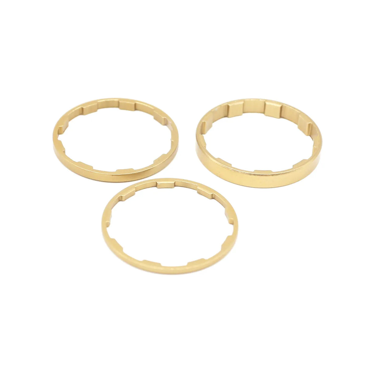 Yoshoka Sprocket Spacers Kit with gold-toned aluminum spacers, three rings with internal notches, SSS Racing branding logo.
