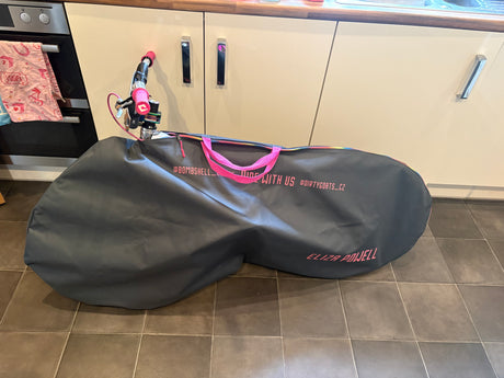 Bombshell Bike Bag, SSS Racing, charcoal gray with neon pink handles, zipper pulls, durable water-resistant fabric, logo.