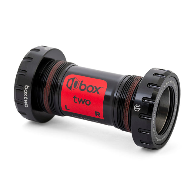 Box Two Oversized 30mm Bottom Bracket SSS Racing: black anodized aluminum body, red label, knurled caps, sealed bearings.