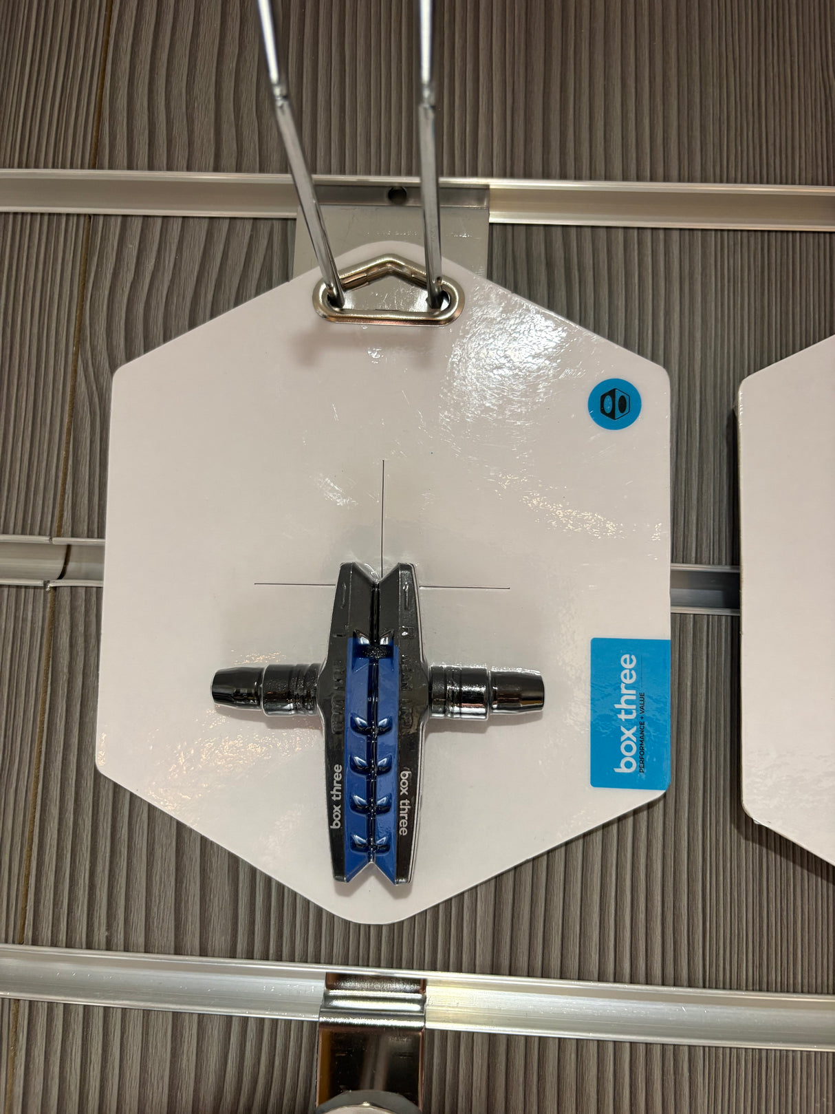SSS Racing Box Three 70mm Brake Shoes: blue central shoe with silver end caps, chrome fittings, displayed on a white card