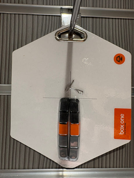 Box One Replacement Brake Pads 70mm by SSS Racing black and orange composite pads with silver metal backs on white card.