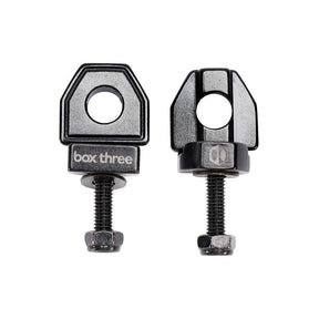 SSS Racing Box Three Chain Tensioners (single hole) in black anodized aluminum, precise threaded stud, clamp, glossy finish.