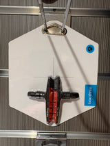 Box Three 70mm Brake Shoes by SSS Racing: red ceramic pads, black alloy backing, silver axles, mounted on white display tag