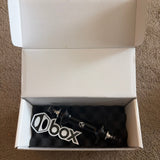 Box Three Stealth Expert Front Hub, black cylindrical hub with silver end caps, visible fittings inside a white open box.