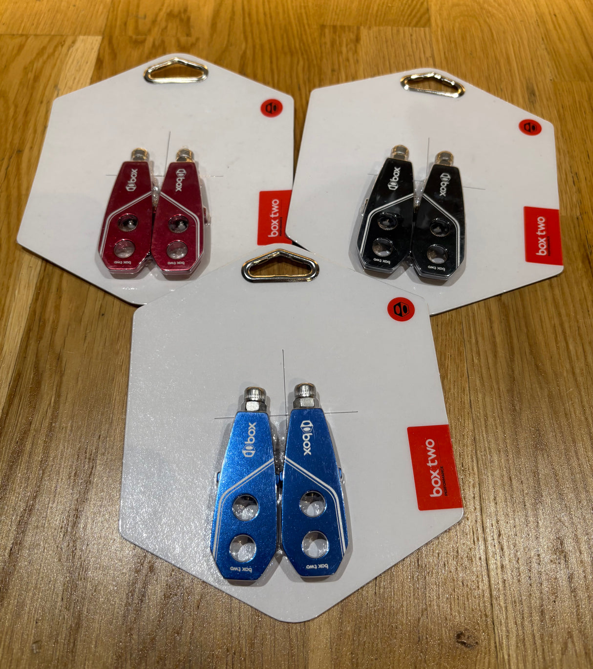 SSS Racing Box Two Chain Tensioners in blue aluminum, red and black variants with silver bolts, cutouts and glossy finish