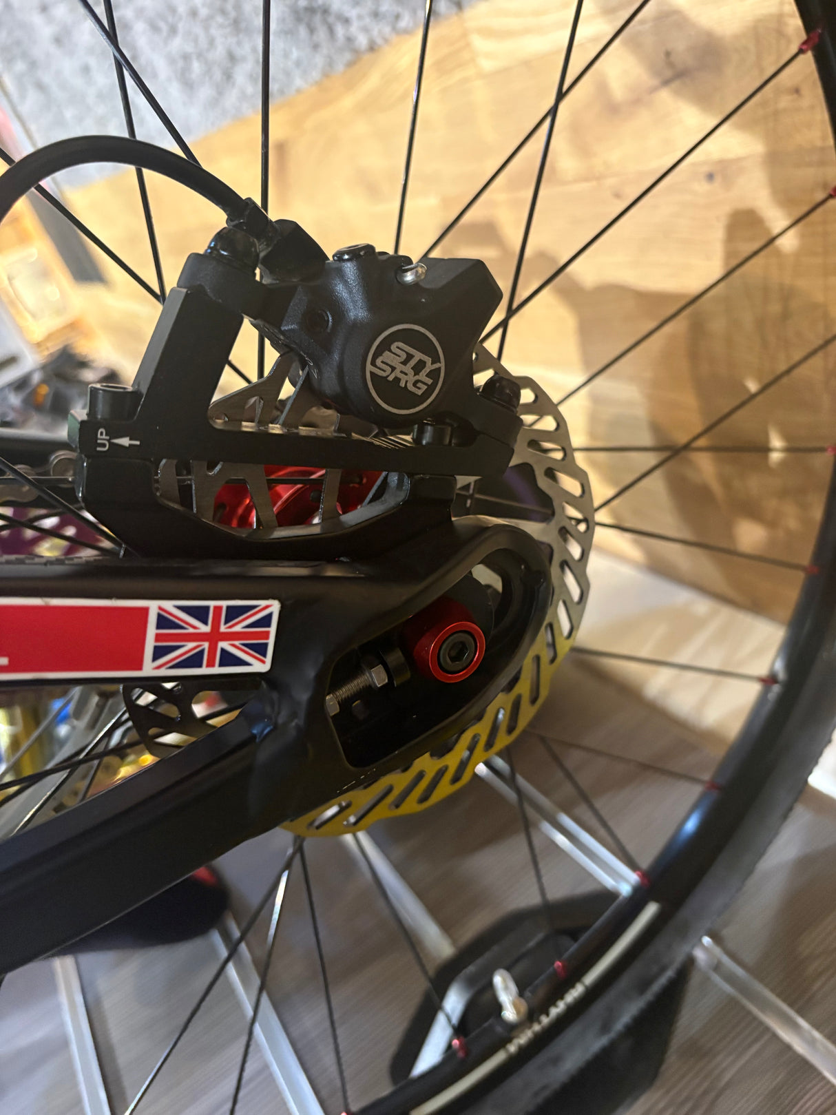 Disc Brake Mount Adapter (Larger Rotor) SSS Racing black anodized aluminum with silver bolts, mounts beside the disc on MTB