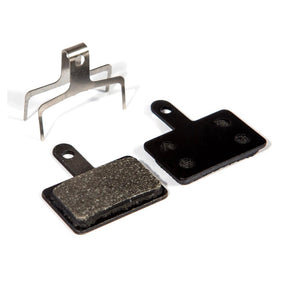 Fibrax High Performance Disc Brake Pads for Shimano Deore, black rectangular pads with metal tab and silver clip on white
