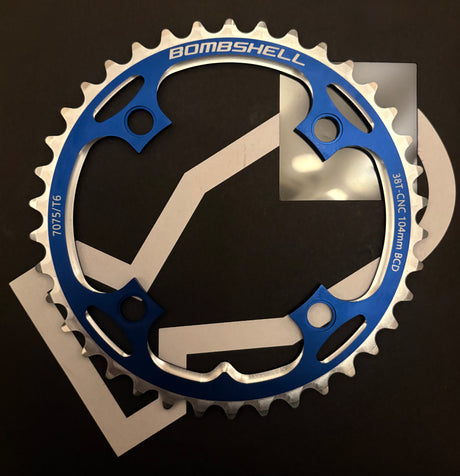 Bombshell Chainring by SSS Racing in blue anodized aluminum with silver CNC teeth, cutouts, 104mm BCD, 7075/T6 lightweight