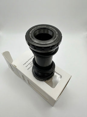 SSS Racing Box Two Bottom Bracket Set 24mm, black anodized aluminum, silver accents, grooved ring, compact cylindrical unit.
