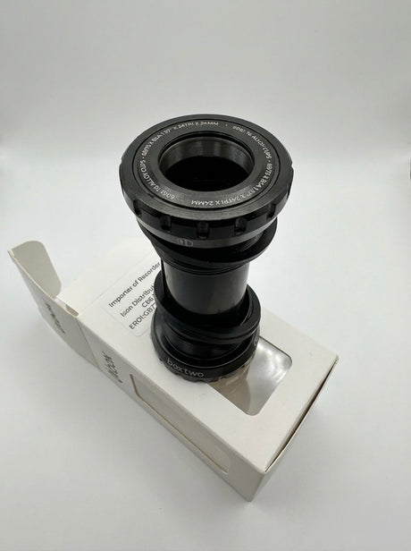 SSS Racing Box Two Bottom Bracket Set 24mm, black anodized aluminum, silver accents, grooved ring, compact cylindrical unit.