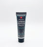 SSS Racing Carbon Fibre Gripper Paste tube: dark blue body, teal trim, silver cap, carbon graphics, 10g squeeze tube on desk