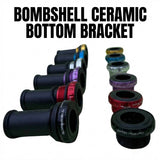 Bombshell Ceramic Euro Bottom Bracket by SSS Racing showing black anodized bodies and red/blue/purple collars with seals.