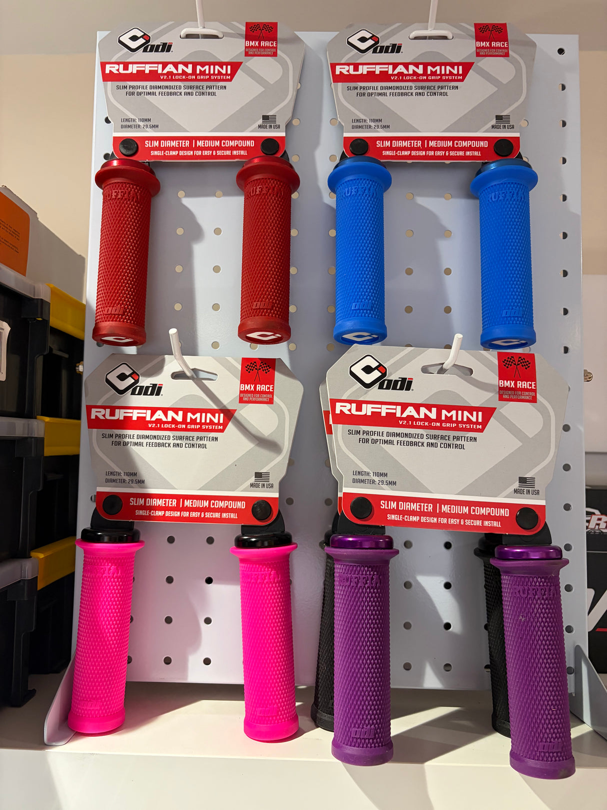 ODI Ruffian Mini Grips red and blue pairs shown; slim cylindrical grips with diamond textured surface and knurling pattern.