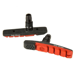 SSS Racing Box Three 70mm Brake Shoes in black and red rubber with ribbed bodies, orange bold accents, alloy mounting pins.