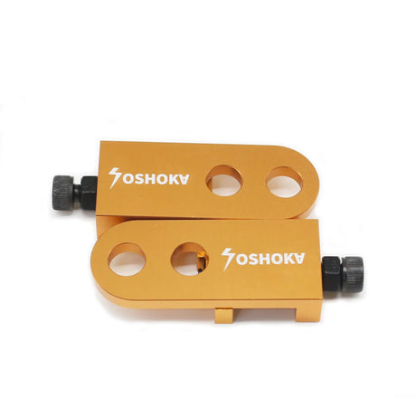 Yoshoka Two-Hole Chain Tensioner by SSS Racing, orange anodized aluminum block with black knurled screws and two holes..