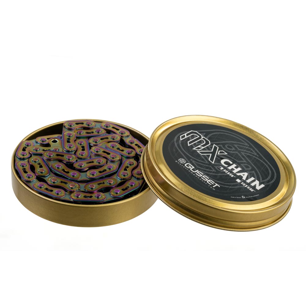 Gusset Oil Slick MX Chain 1/8" in a gold tin, iridescent oil-slick purple-green links, steel core. Ideal for BMX racing. 