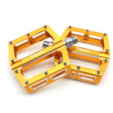 Yoshoka Race Pedal YSA-BRP303 by SSS Racing in orange anodized aluminum, textured grip, silver bolts, rectangular frame.