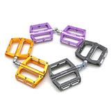 Yoshoka Race Pedal YSA-BRP303 by SSS Racing: anodized aluminum orange, purple, gray pedals with stainless bolts and grips.