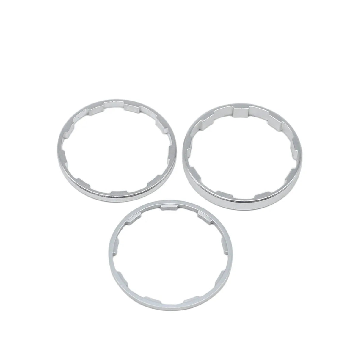 Yoshoka Sprocket Spacers Kit by SSS Racing: polished silver stainless steel rings, three round spacers with internal notches.