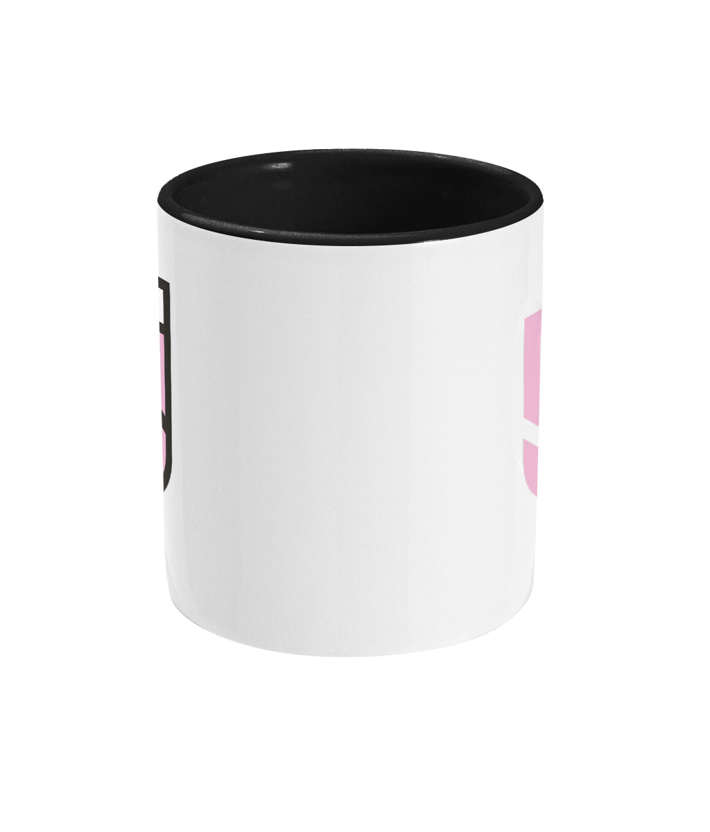 SSS Racing Two Tone Mug: white ceramic mug with black interior, pink side accents, bold logo wrap, glossy finish with trim.